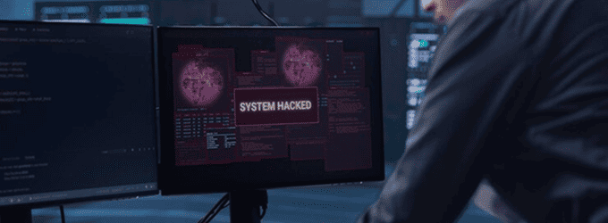Security analyst responds to a live system breach notification on a monitoring dashboard in a SOC environment