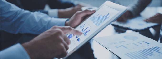 Collaborative business meeting focused on visual reports and interactive data presentations
