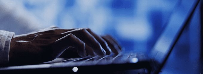 Software engineer working on a digital product, focused on coding and monitoring data in a modern office