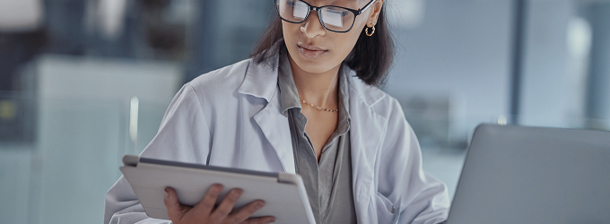 Clinician accesses patient health records on a tablet to update treatment plans and med charts.