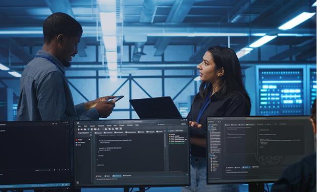 Software consultants coordinating on technical tasks for agile development and IT security management

