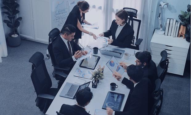 IT project team collaborating on digital transformation strategy in a boardroom meeting
