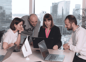 Focused product team holding a brainstorming session in a modern workspace