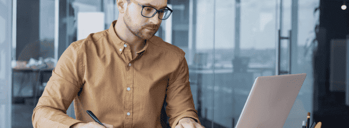 Software engineer managing tasks on a laptop, focused on a project in a technology-driven environment