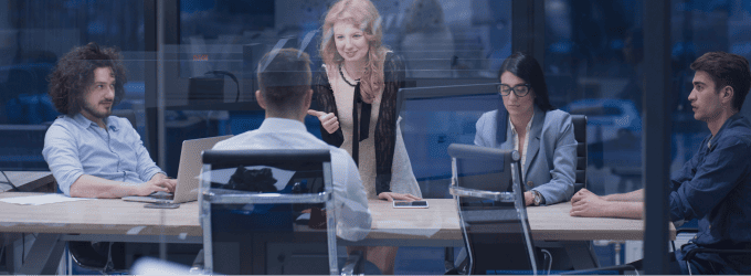 Executive team discussing software integration plans and analyzing progress data