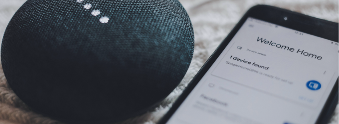 IoT mobile app setup screen on a phone paired with a voice-enabled smart speaker