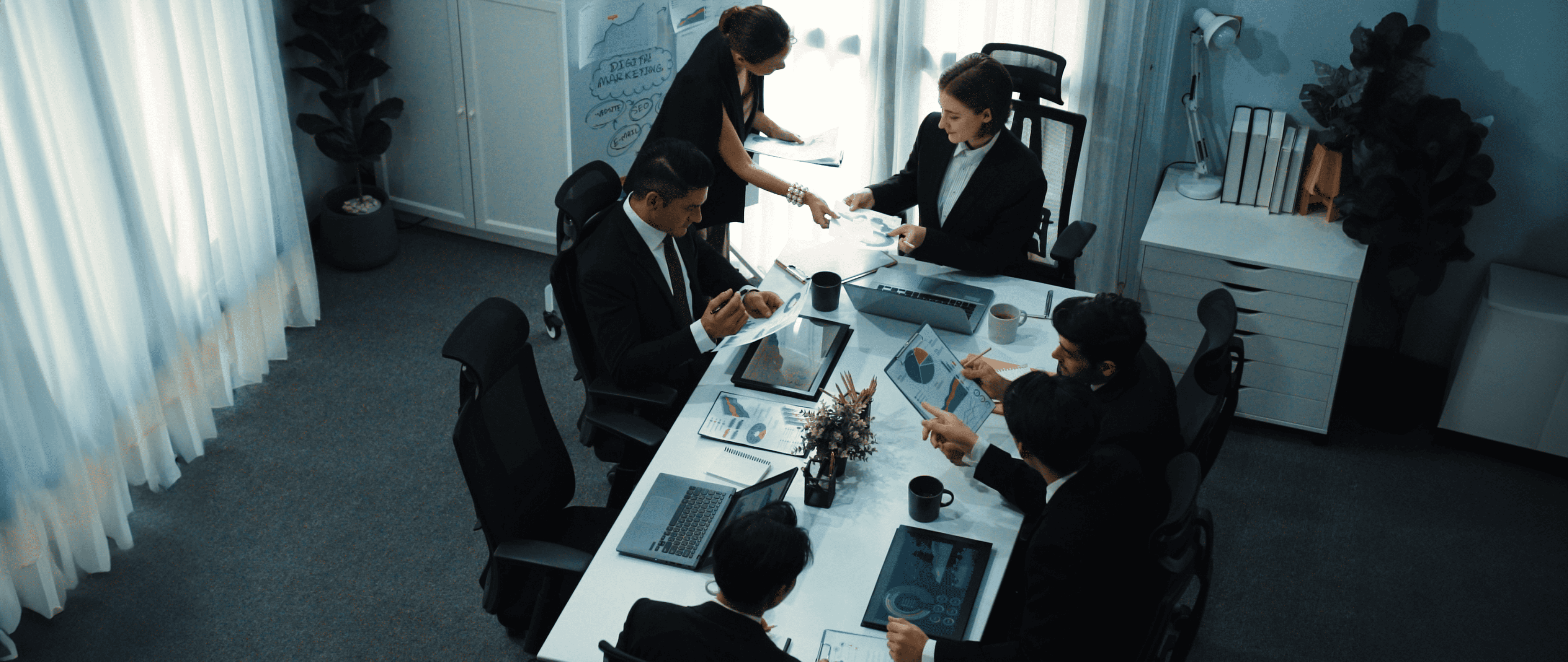 IT project team collaborating on digital transformation strategy in a boardroom meeting