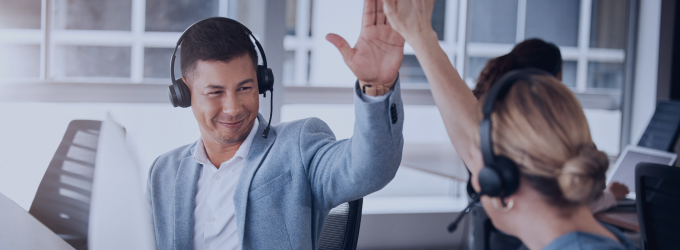 Project manager celebrating successful system integration with distributed support team