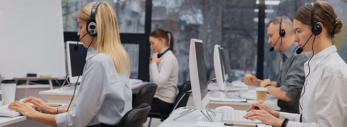 IT support specialists handling client inquiries at a busy technical service center